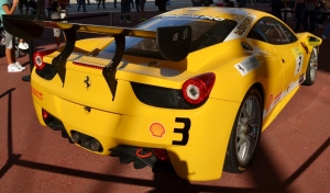 Nadia Mikushova. A backside view to the new Ferrari car exposed at the EXPO2015.