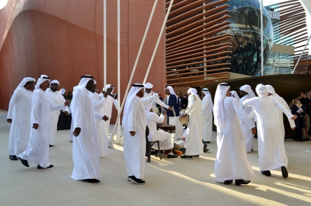 Expo2015.Dancers from United ArabEmirates and partial view to AzerbaijanPavilion.s